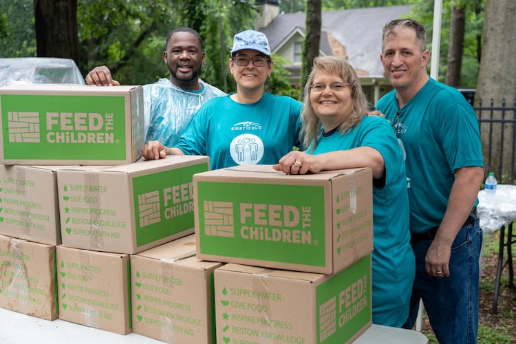 Voluntarios en un acto con cajas de Feed the Children